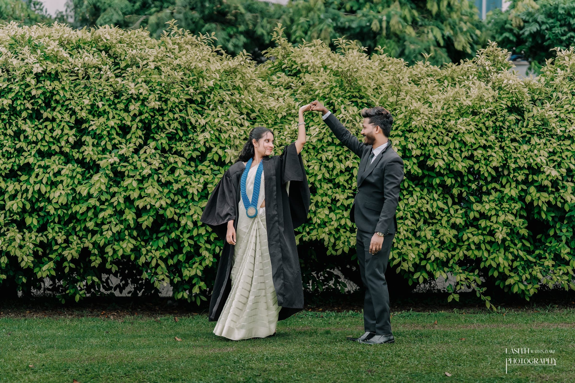 A graduate in his gown with his scroll, photo 7 of 7