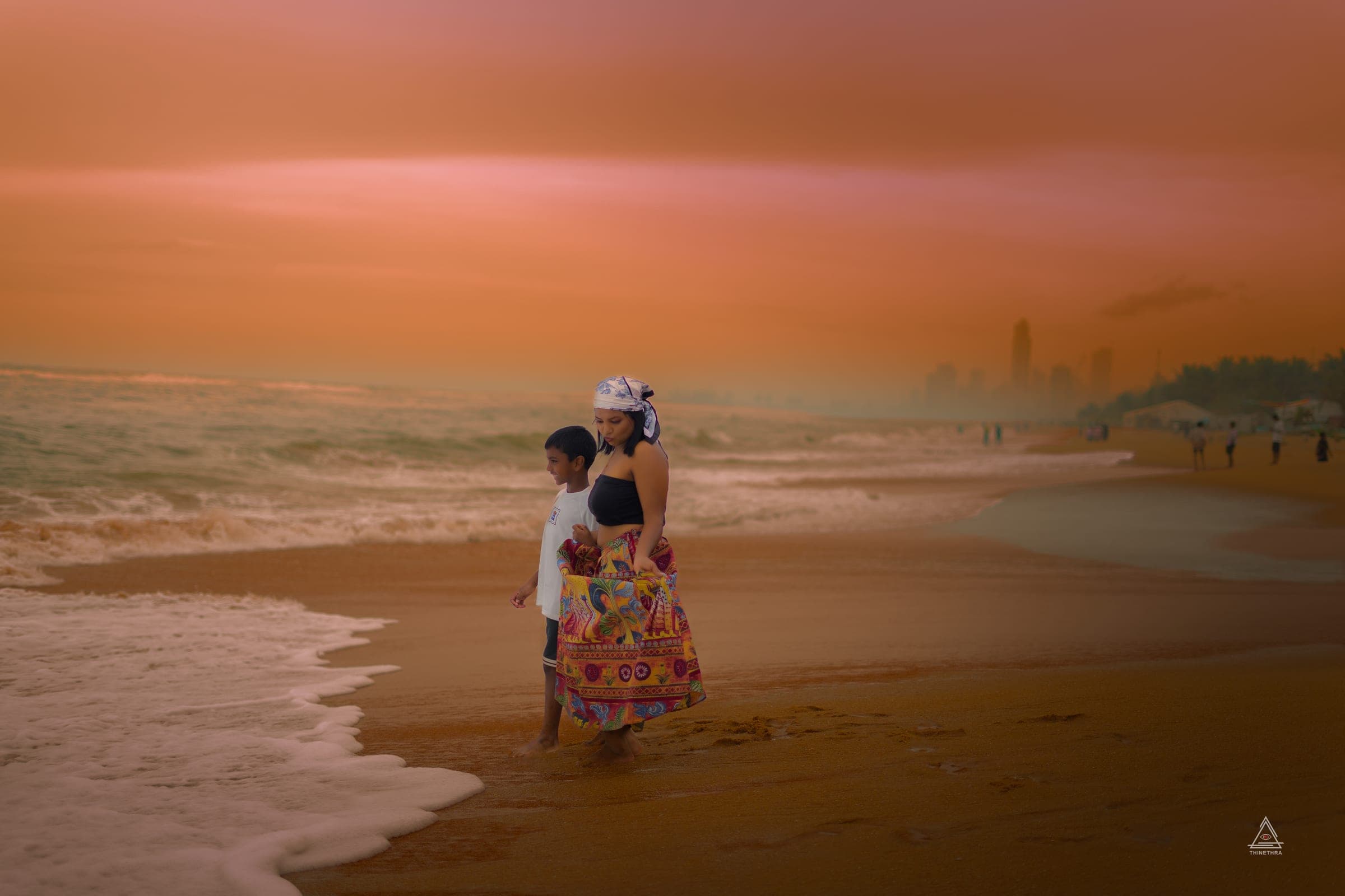 Chandima and her son on the beach at sunset, photo 7 of 13