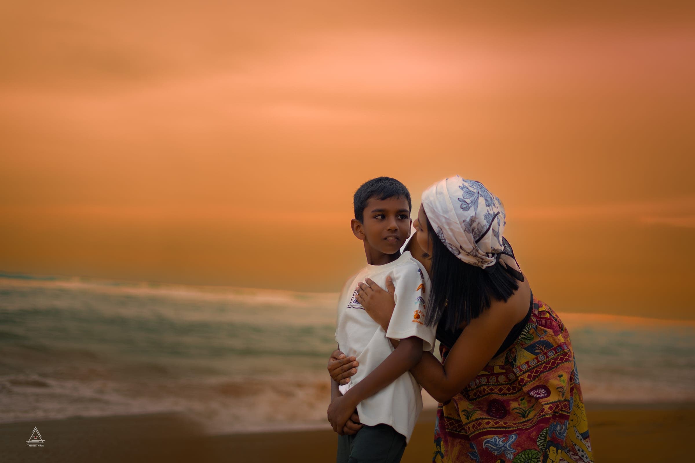 Chandima and her son on the beach at sunset, photo 9 of 13