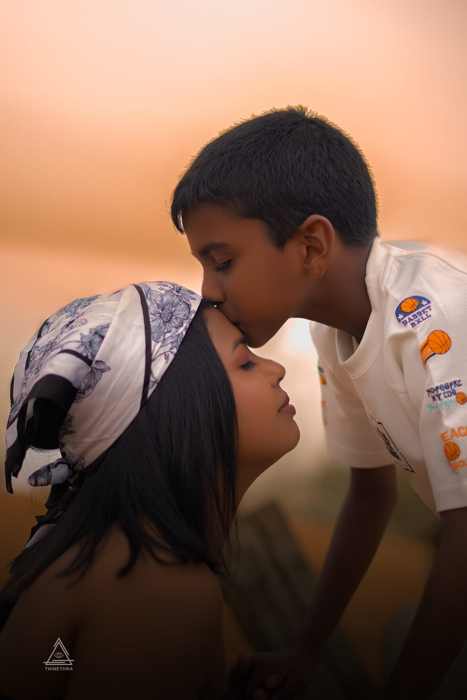 Chandima and her son on the beach at sunset, photo 12 of 13